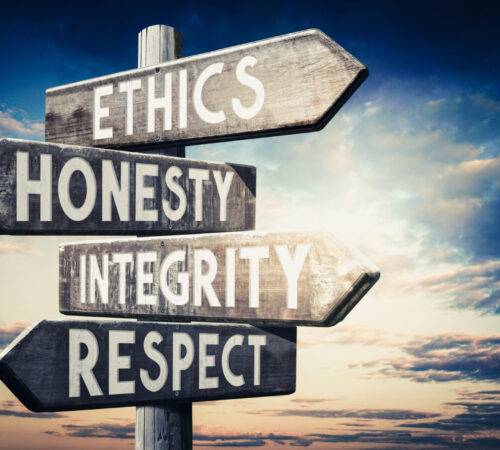 ethics-honesty-integrity-respect-wooden-signpost-with-four-arrows-sunset-sky-background